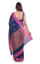 Woman wearing a blue and pink saree with gold patterns on a white background