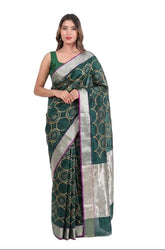 Woman wearing a green saree with a white background