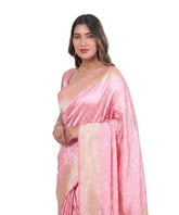 Woman wearing a pink saree with a white background