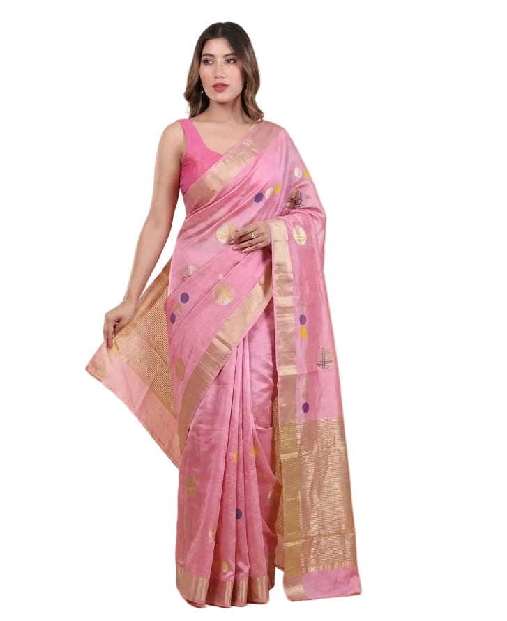 Woman wearing a pink saree with a gold border on a beige background