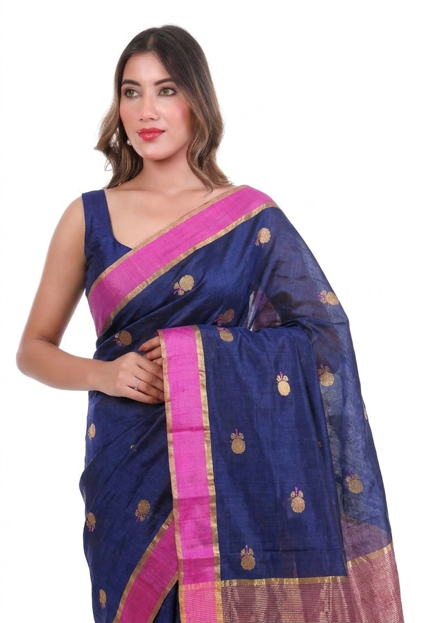Woman wearing a blue saree with pink border on a white background