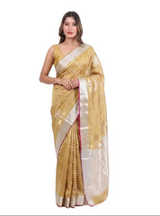 Woman wearing a gold saree with a white blouse on a white background