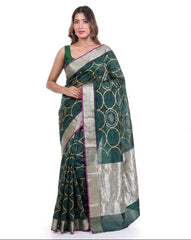 Woman wearing a green and white saree with a white background